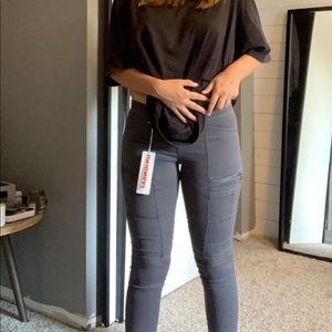 gray jeans with zips on pockets